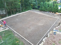 Next step is a form for the concrete base of a residential basketball court in shades of blue in Lexington, MA.