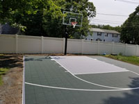 Green and gray residential basketball court in Reading, MA.