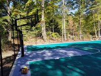Side view of hoop end of basketball court in Bolton, MA.