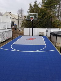 Small blue bakyard basketball court in Braintree, MA.