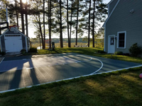 Backyard basketball court in Duxbury, MA. Surfaces for a variety of sports are available.