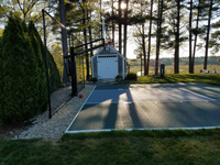 Backyard basketball court in Duxbury, MA A variety of games and court accessories are available.