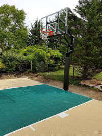 Small sand and green colored basketball court in Easton, MA.