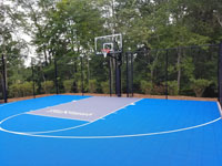 Blue and titanium court with custom Maximus logo, done in association with a landscaper doing a complete makeover, in Easton, MA.