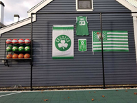 Backyard basketball court is the sort of thing you might find in Fairhaven, MA or a yard like yours. Showing off customer embellishments to their court area, with basketball rack, Celtics banners, and Larry Bird shirt.