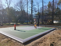Backyard basketball court and batting cage in Hanover, MA.