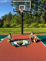 Kids on home basketball court with logo in Londonderry, NH.