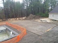 Form and reinforcement show prior to pouring cement base for green and black basketball court in Marion, MA.