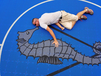 Bob loves this custom logo, and gives an idea of the scale of the image and large royal blue and titanium basketball court with golf seahorse logo at Bay Club in Mattapoisett, MA.