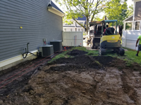 Removing grass and topsoil into truck/ shown below, part of preparing the way for a slate green and titanium silver/grey basketball court in Needham, MA.
