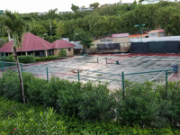 Old, worn Caribbean tennis court before Naturescape restoration at Sandals Grande Antigua Resort and Spa in St. Johns, Antigua.