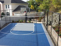Backyard basketball court plus net for tennis, volleyball or pickleball, with landscaping, patio and wall in Stoneham, MA.