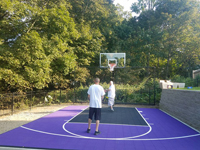 Purple and black backyard basketball court in Stoneham, MA.