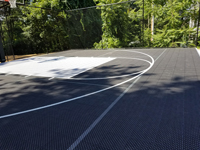 Black and grey home backyard basketball court in Wellesley, MA.