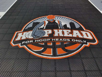 Closeup of Hoop Heads custom logo on home basketball court in Boston, MA.