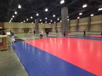 Construction of volleyball courts in convention center for New England Regional Volleyball Association (NERVA) Winterfest 2020 tournament in Hartford, CT, using Versacourt indoor sport tiles.