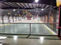 We traveled to Kapolei, Hawaii and inside to resurface two inline skate hockey rinks with Versacourt Speed Indoor tile. This is a photo from the elevated bleacher area at one end, through the safety netting, before the work began.