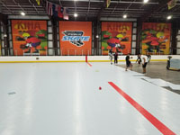 We traveled to Kapolei, Hawaii and inside to resurface two inline skate hockey rinks with Versacourt Speed Indoor tile. This is a picture of the work being done near the center of the first court, only partially completed.