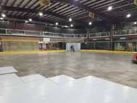 We traveled to Kapolei, Hawaii and inside to resurface two inline skate hockey rinks with Versacourt Speed Indoor tile. This is a picture of one corner of the court under construction, showing materials being staged for the next phase.