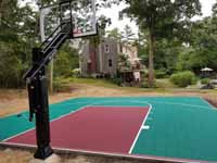 Green and red residential basketball court in Middleborough, MA.