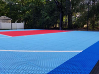 Low to the surface, angled view of three color basketball court in North Attleboro, MA.