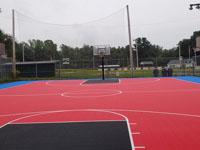 Red, black, and blue municipal basketball court replacement in Paxton, MA.