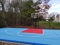 Three color, blues and red, basketball court in a lucky yard in Shirley, MA.