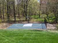 Backyard basketball court, in Versacourt slate green and titanium, in Stow, MA. This is a similar view of the finished court compared to the base preparation in the adjacent picture.