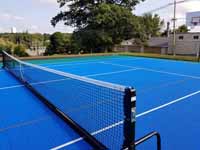 Portable net for tennis and pickleball on Middleboro, MA town court.