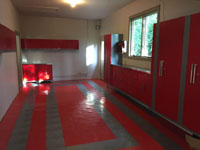 Red and grey tile floor colors coordinate with workshop fixtures in this example photo.
