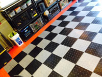 Image of a potential garage floor installation of black and white tiles.