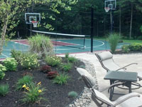 Backyard basketball court with pool deck and landscaping in Kingston, MA