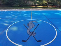 Mattapoisett Bay Country Club logo of seahorse with golf clubs at center of large basketball court for members.