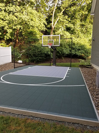 Small green side yard basketball court in Needham, MA.